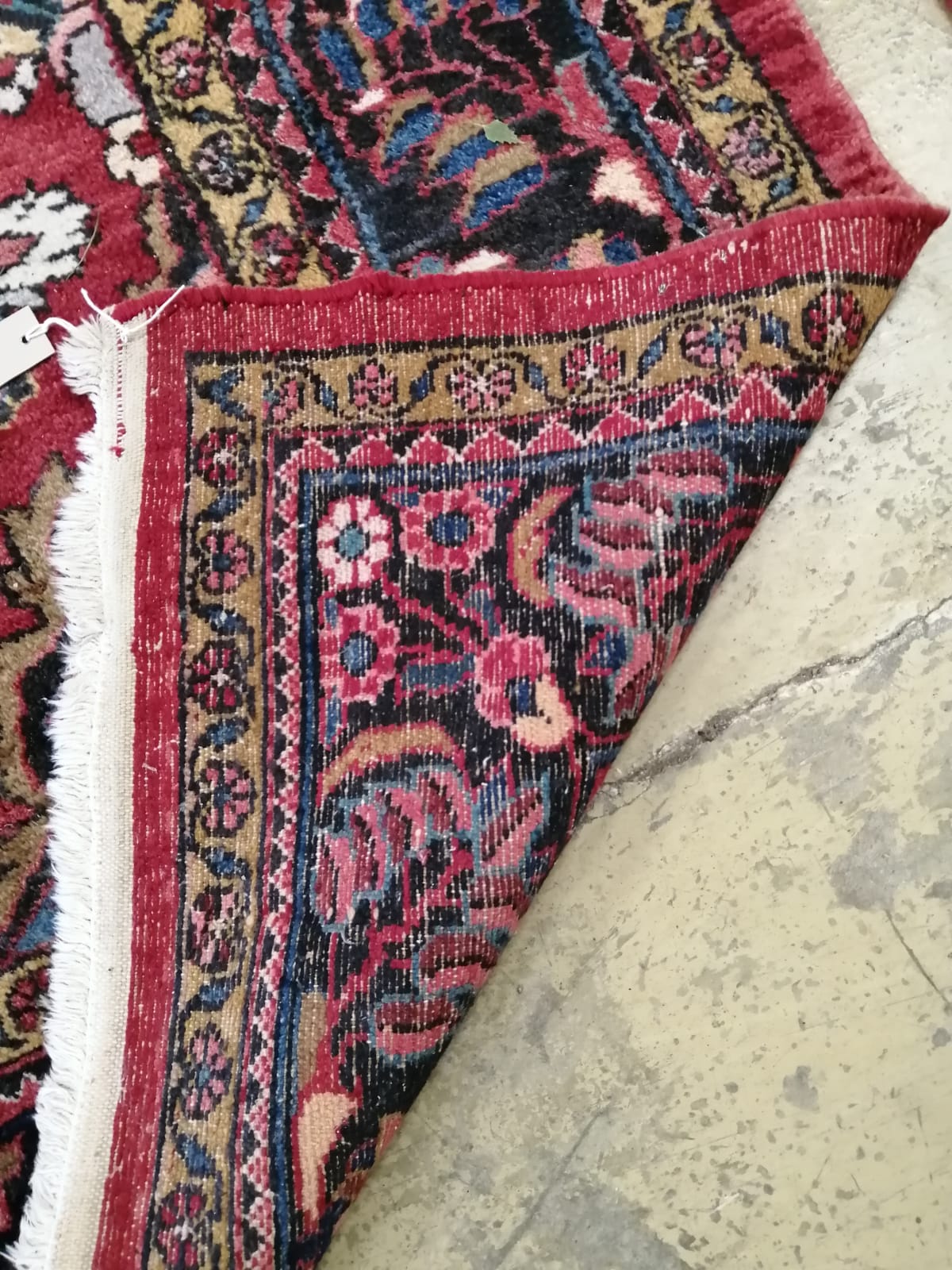 A Tabriz red ground carpet, 345cm x 241cm